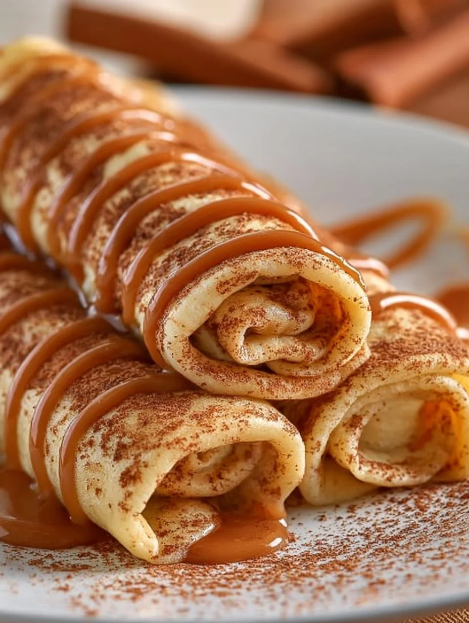 Delicious cinnamon roll protein crepes topped with cinnamon and cream cheese drizzle