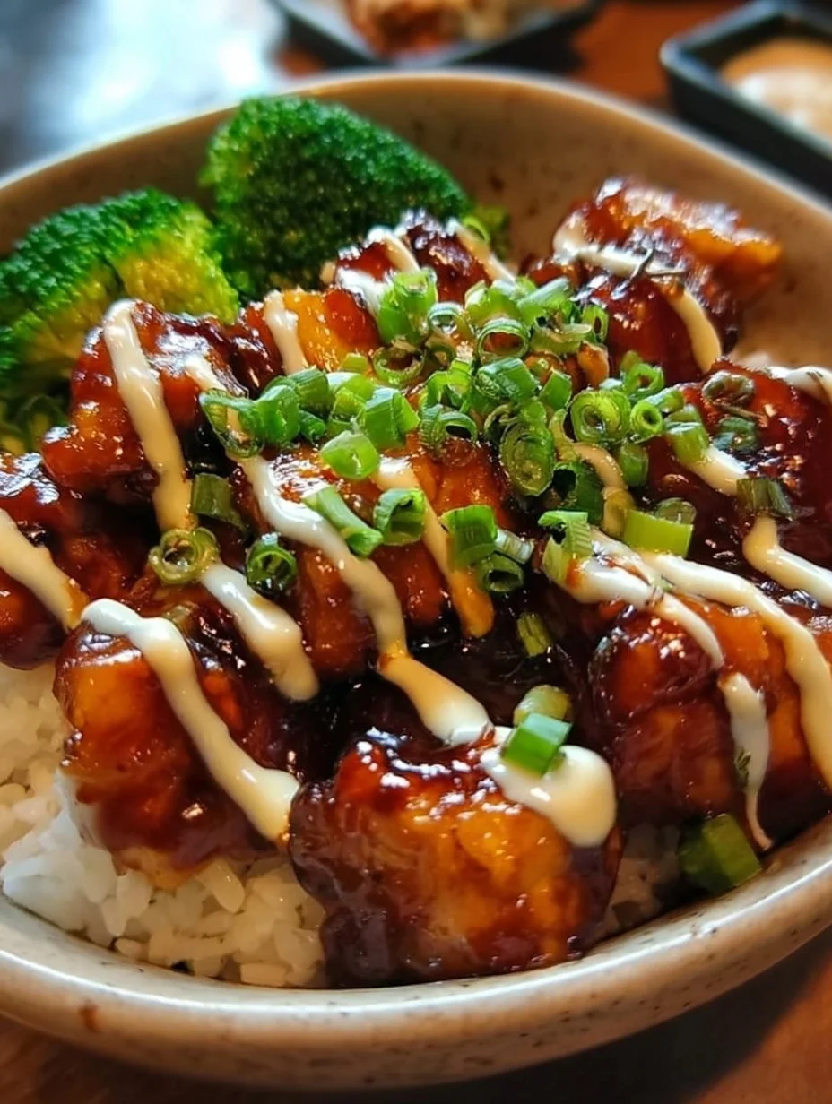 Delicious sticky chicken rice bowls served in a vibrant bowl, perfect for any meal.
